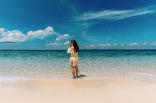 woman enjoying a tropical beach with clear skies
