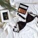 black brassiere and makeup on bed